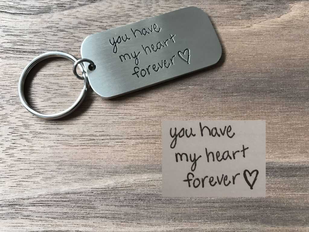 Engraved keychain with the message you have my heart forever on wooden background, ideal for romantic gifts.
