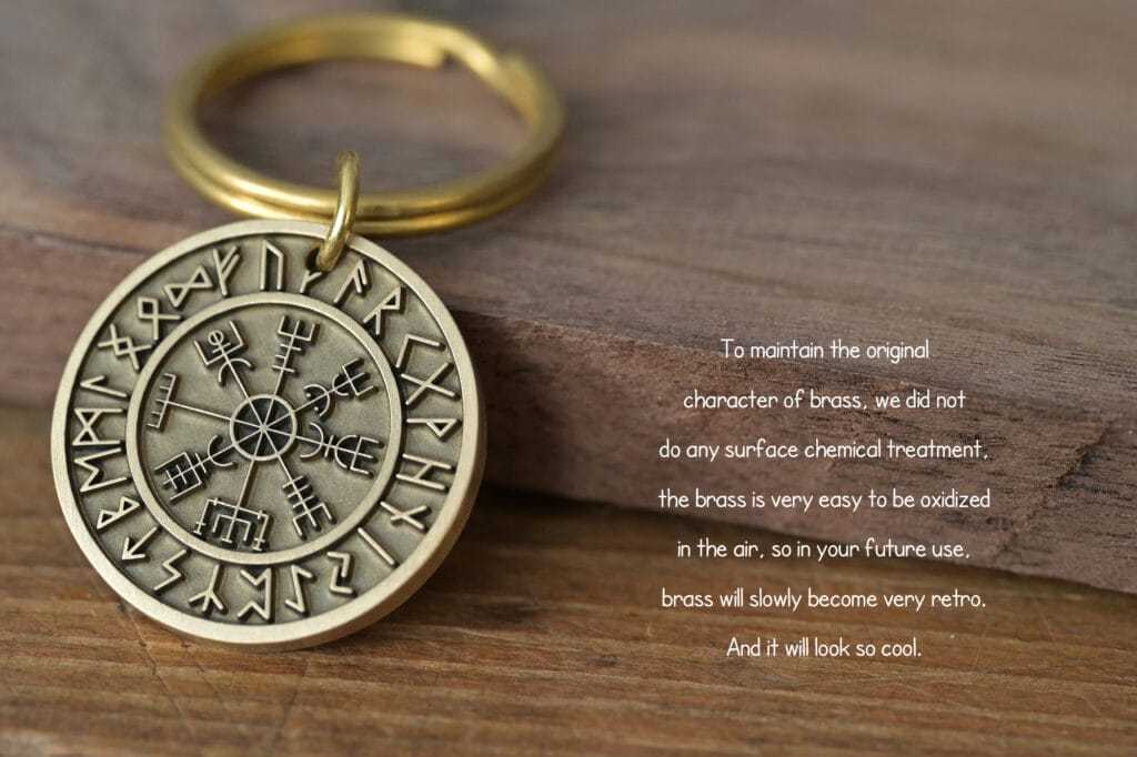 Brass keychain with runic symbols on a wooden surface, untreated for a natural, antique finish.