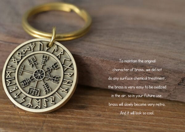 Brass keychain with runic symbols on a wooden surface, untreated for a natural, antique finish.