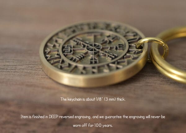Close-up of intricately engraved brass keychain on wooden surface, 3mm thick, boasting durable 100-year-lasting design.