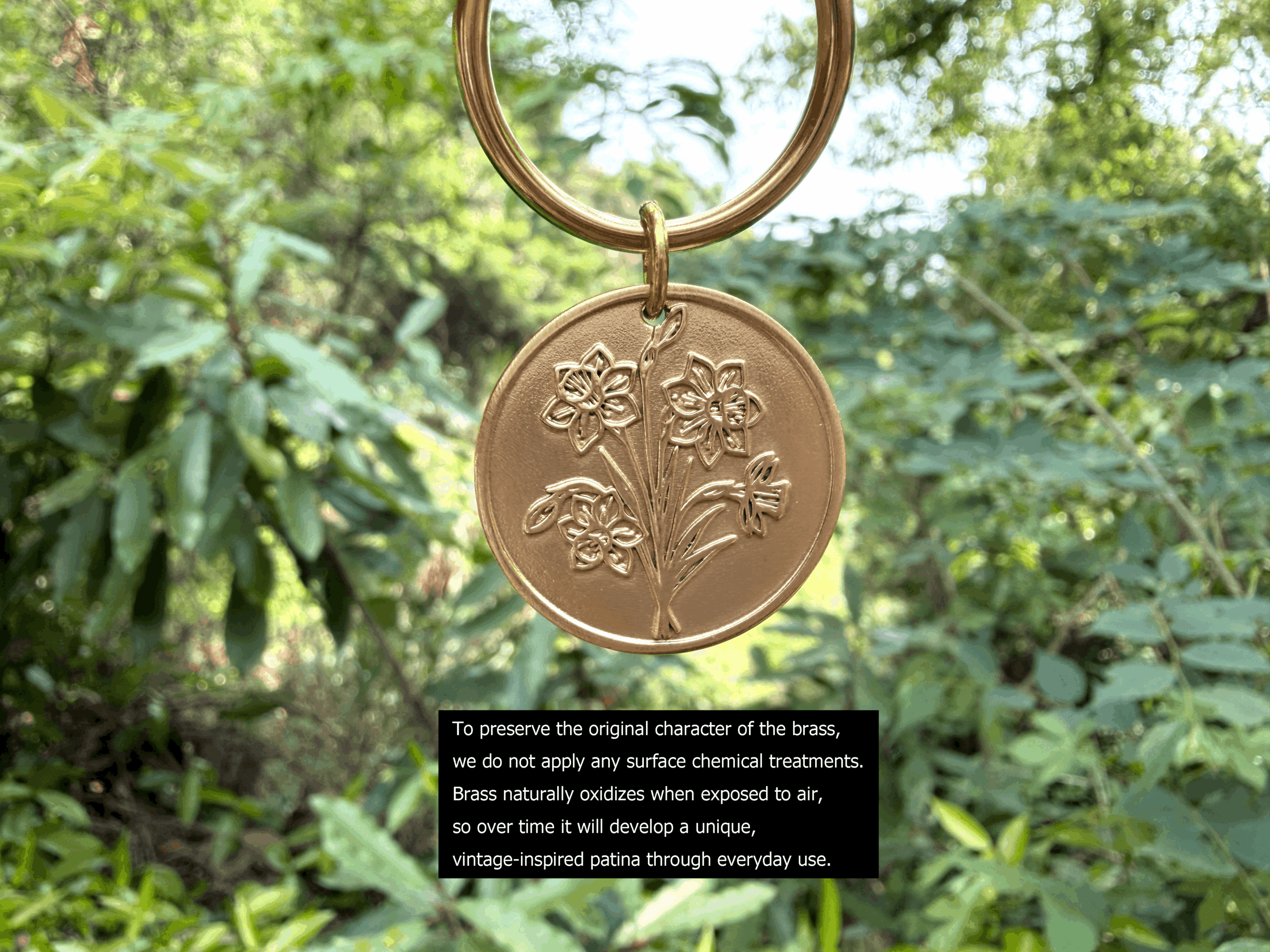 Brass floral pendant hanging outdoors, showcasing natural oxidation for a unique, vintage-inspired patina over time.