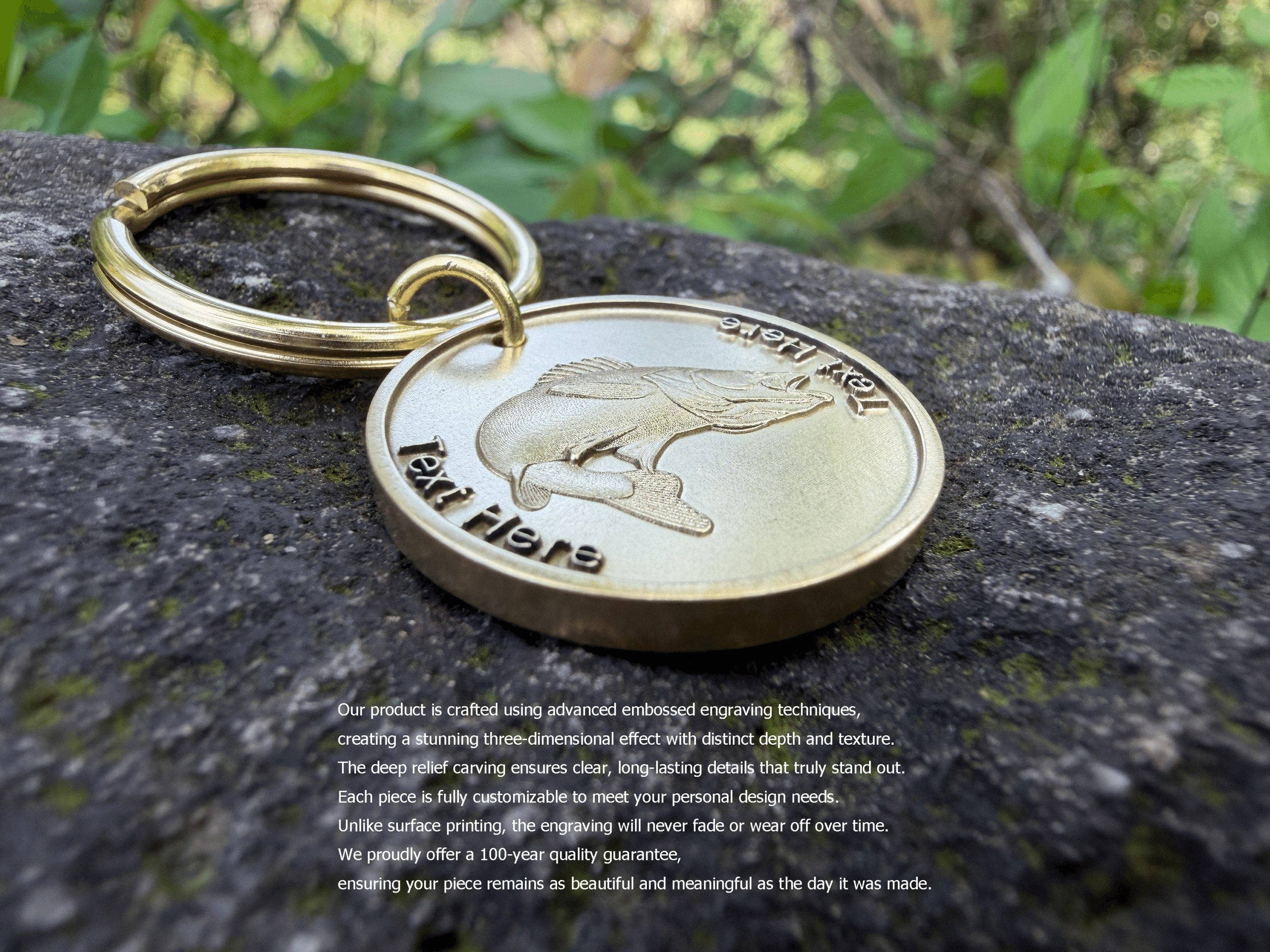 Gold keychain with fish engraving on rock, showcasing detailed craftsmanship and custom text option.