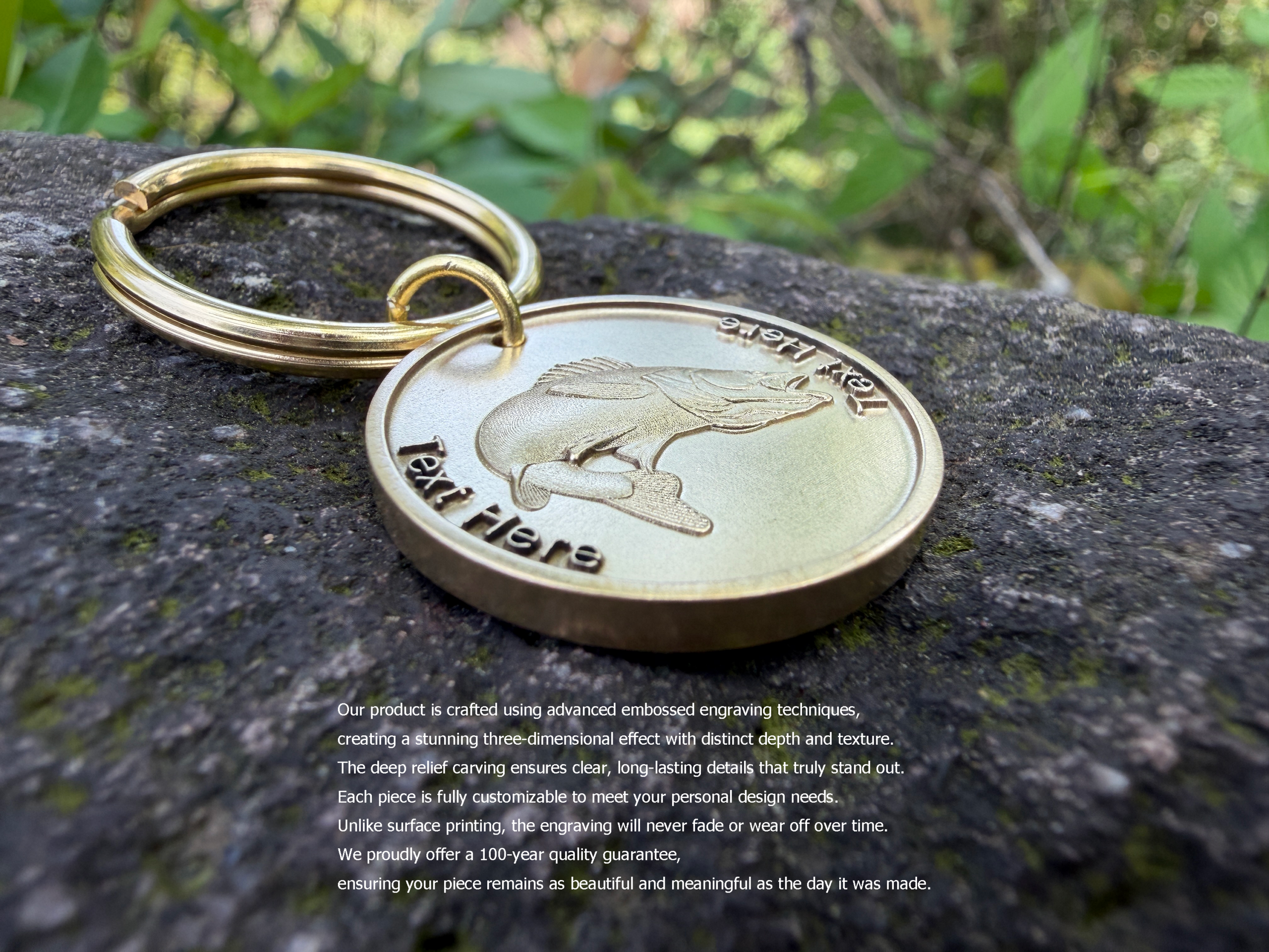 Gold keychain with fish engraving on rock, showcasing detailed craftsmanship and custom text option.