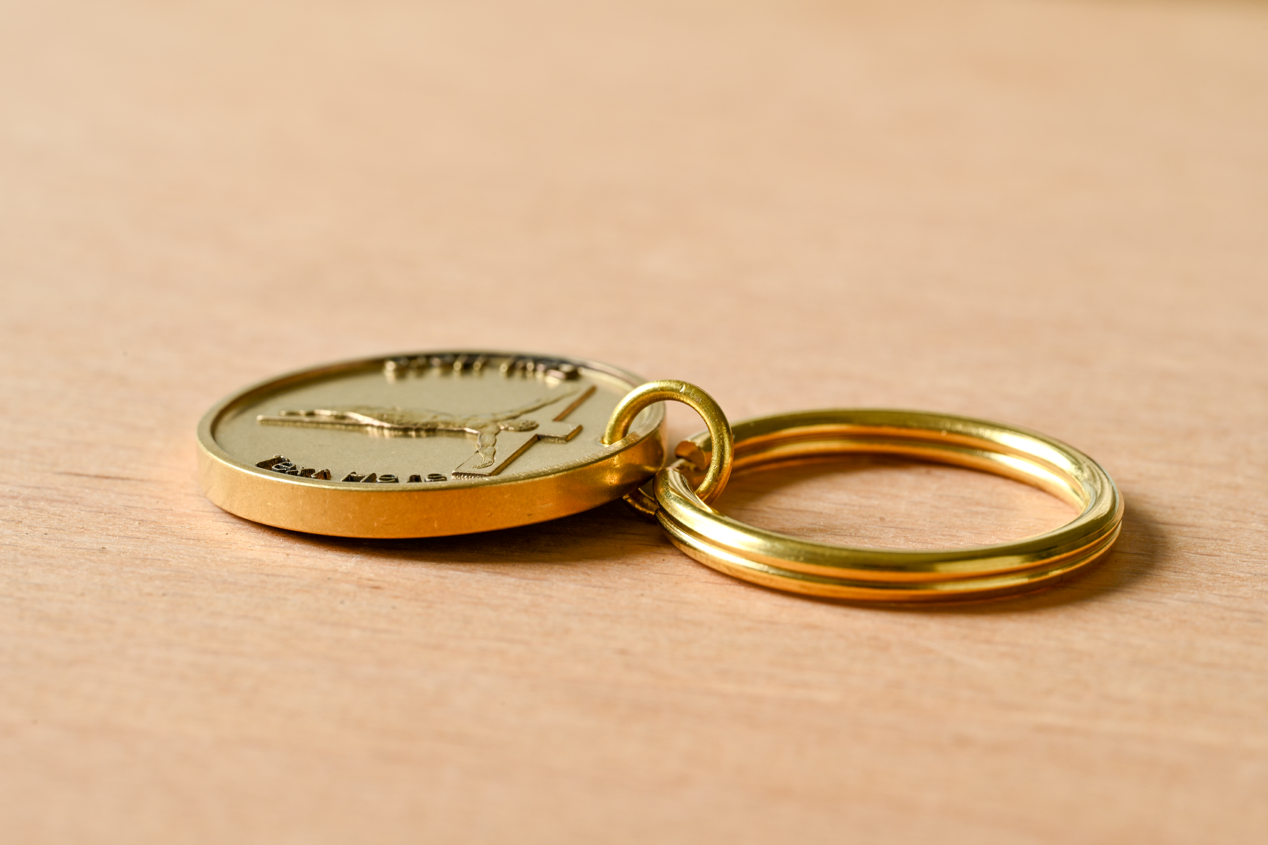 Gold keychain with a medallion depicting the crucifixion of Jesus