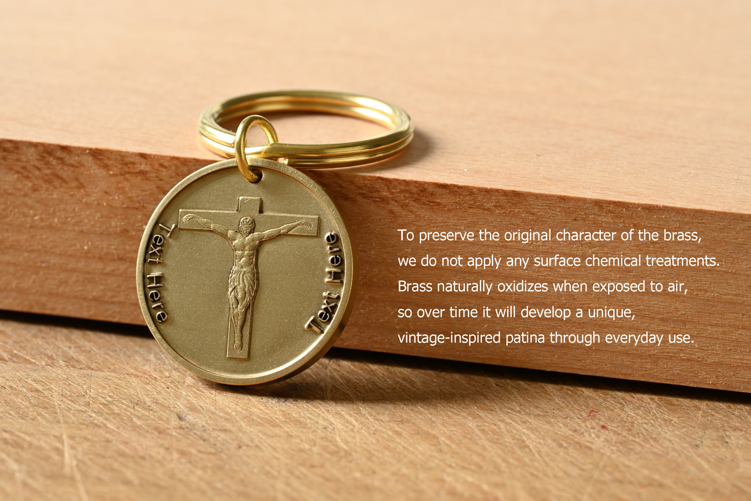 Brass keychain with a crucifix and customizable text. Text explains that untreated brass will naturally oxidize and develop a vintage-inspired patina over time