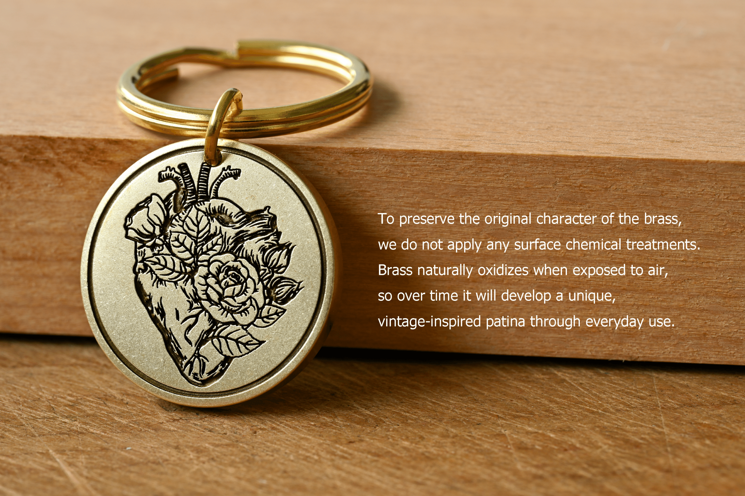 Brass keychain engraved with an anatomical heart and rose, with text: To preserve the original character of the brass, we do not apply any surface chemical treatments. Brass naturally oxidizes when exposed to air, so over time it will develop a unique, vintage-inspired patina through everyday use