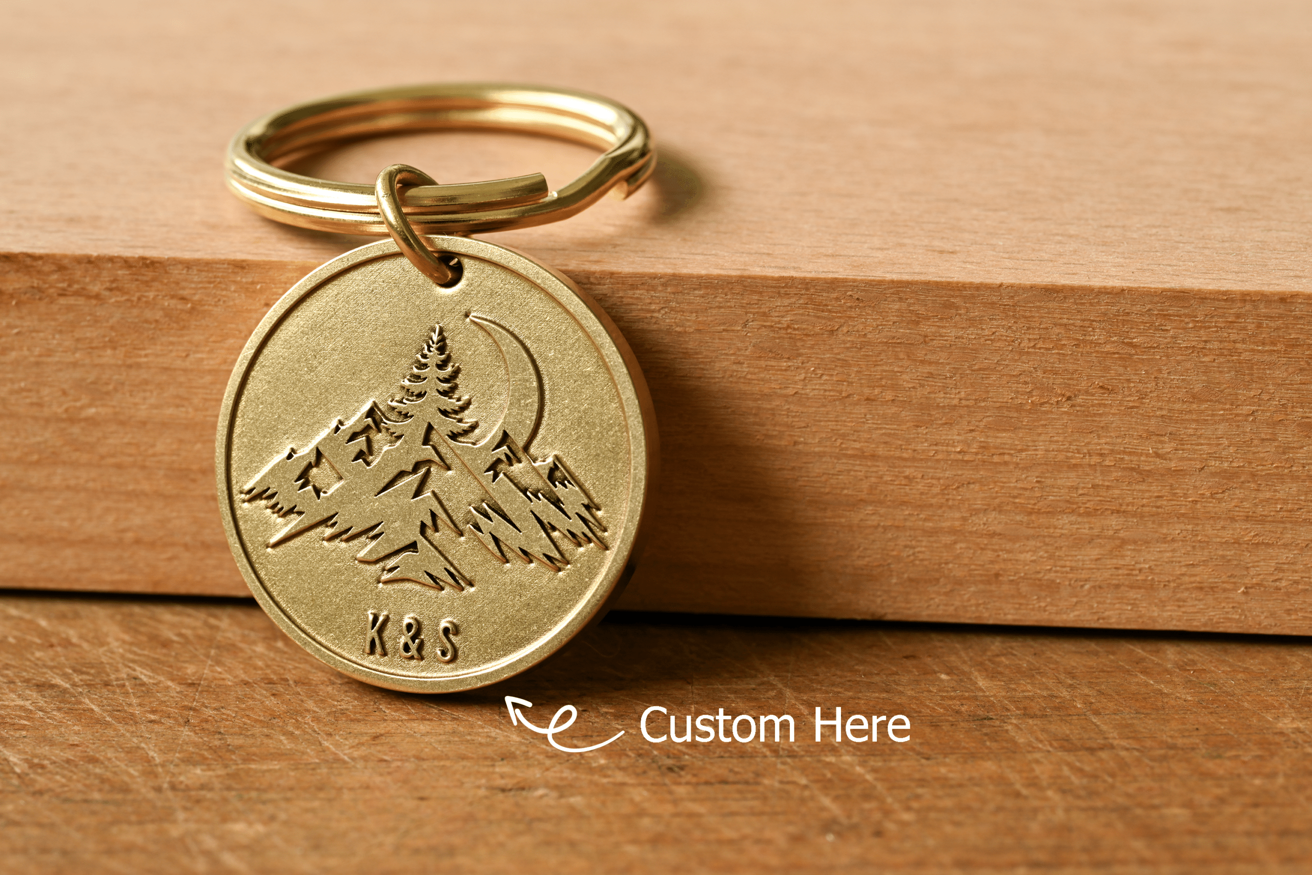 Brass keychain tag with engraved mountains and moon, featuring customizable initials K&S at the bottom