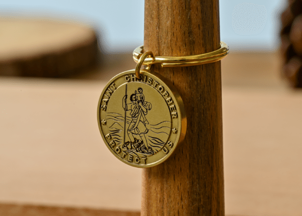 Gold Saint Christopher keychain medallion engraved with the text Saint Christopher Protect Us