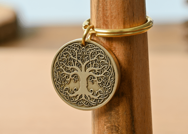 Round bronze keychain medallion featuring a detailed Tree of Life with Celtic knotwork