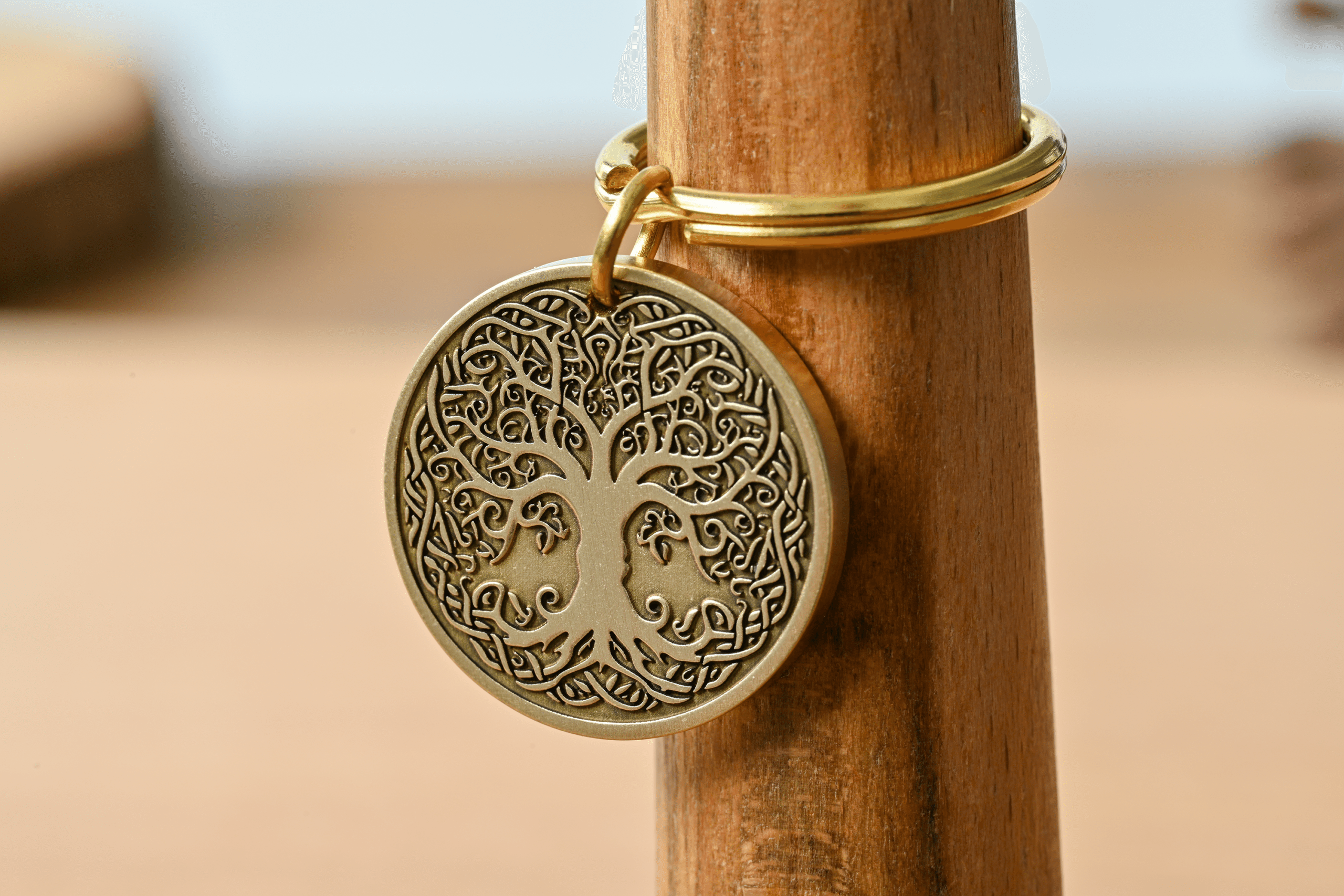 Round bronze keychain medallion featuring a detailed Tree of Life with Celtic knotwork