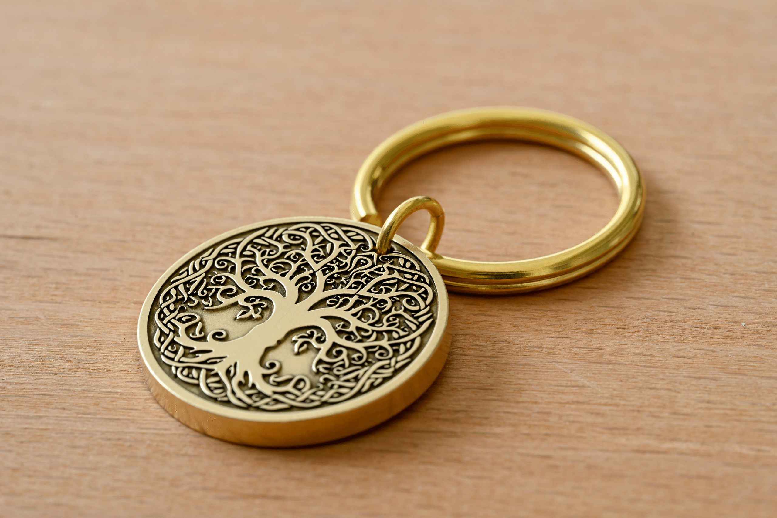 Brass keychain featuring an intricate Tree of Life design on a circular medallion