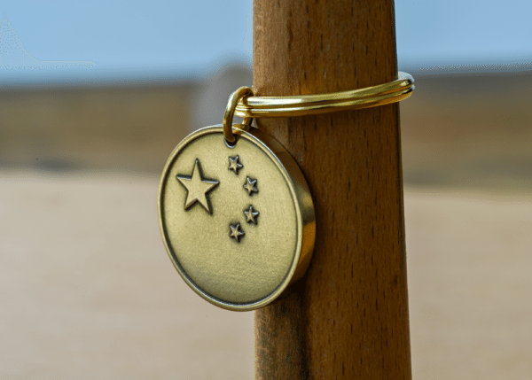 Round brass keychain tag featuring the five-star pattern of the Chinese flag