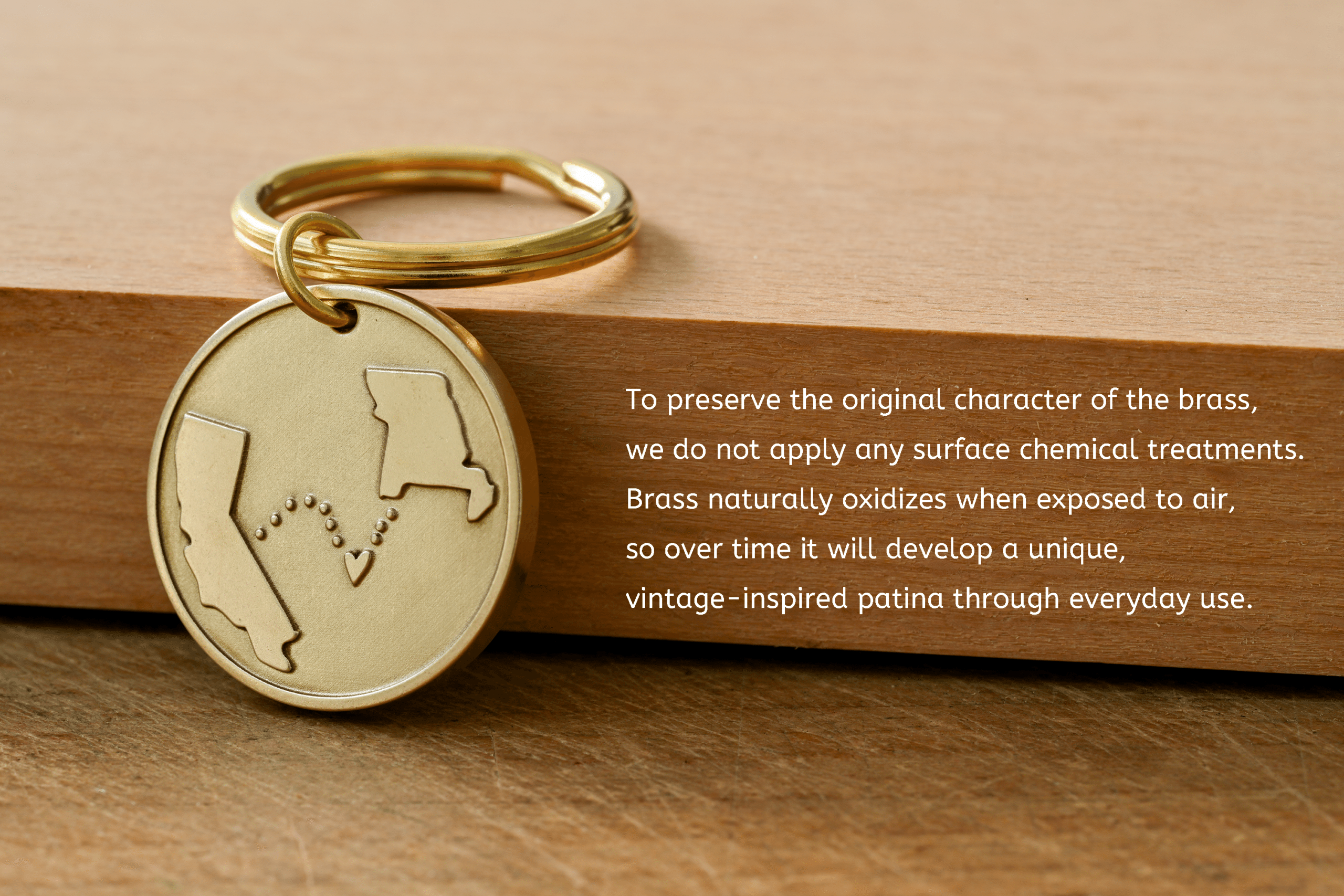 Brass keychain with engraved state outlines next to text: To preserve the original character of the brass, we do not apply any surface chemical treatments. Brass naturally oxidizes when exposed to air, so over time it will develop a unique, vintage-inspired patina through everyday use