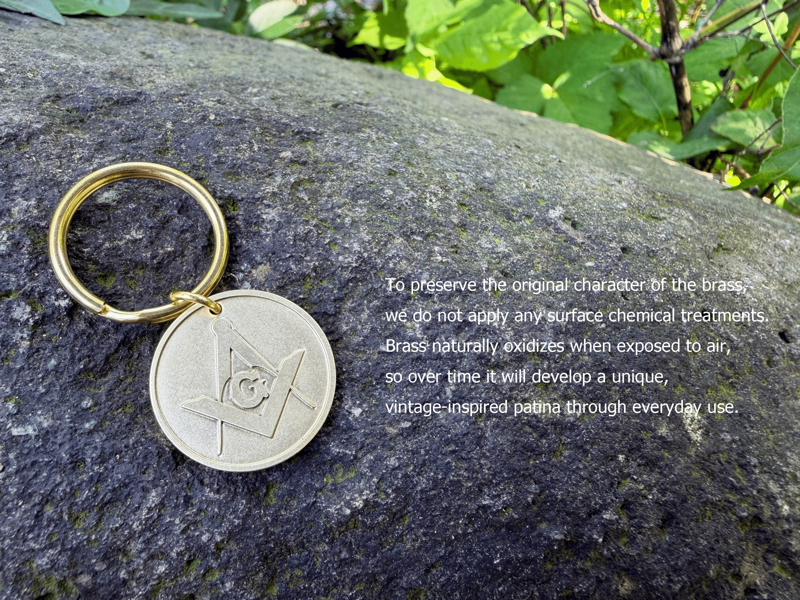 Brass Masonic medallion keychain resting on a rock. To preserve the original character of the brass, we do not apply any surface chemical treatments. Brass naturally oxidizes when exposed to air, so over time it will develop a unique, vintage-inspired patina through everyday use