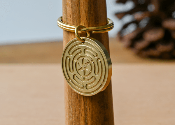 Brass keychain with a circular pendant engraved with a hecate wheel design