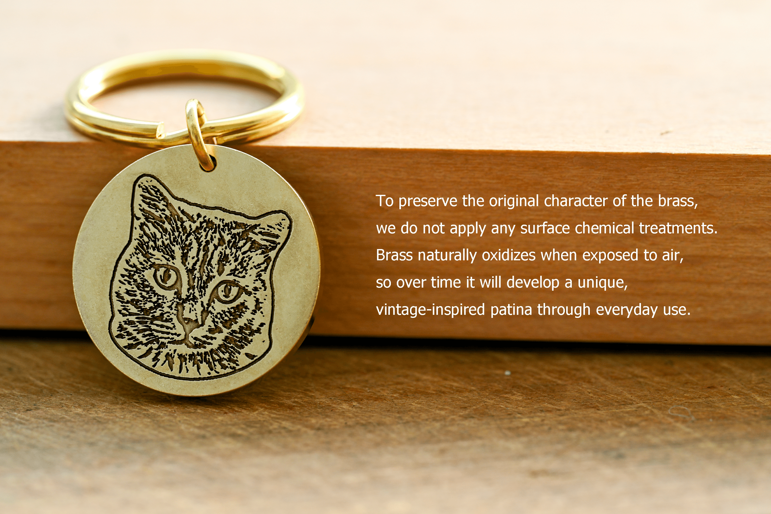 Circular brass keychain engraved with a cat portrait next to text: To preserve the original character of the brass, we do not apply any surface chemical treatments. Brass naturally oxidizes when exposed to air, so over time it will develop a unique, vintage-inspired patina through everyday use