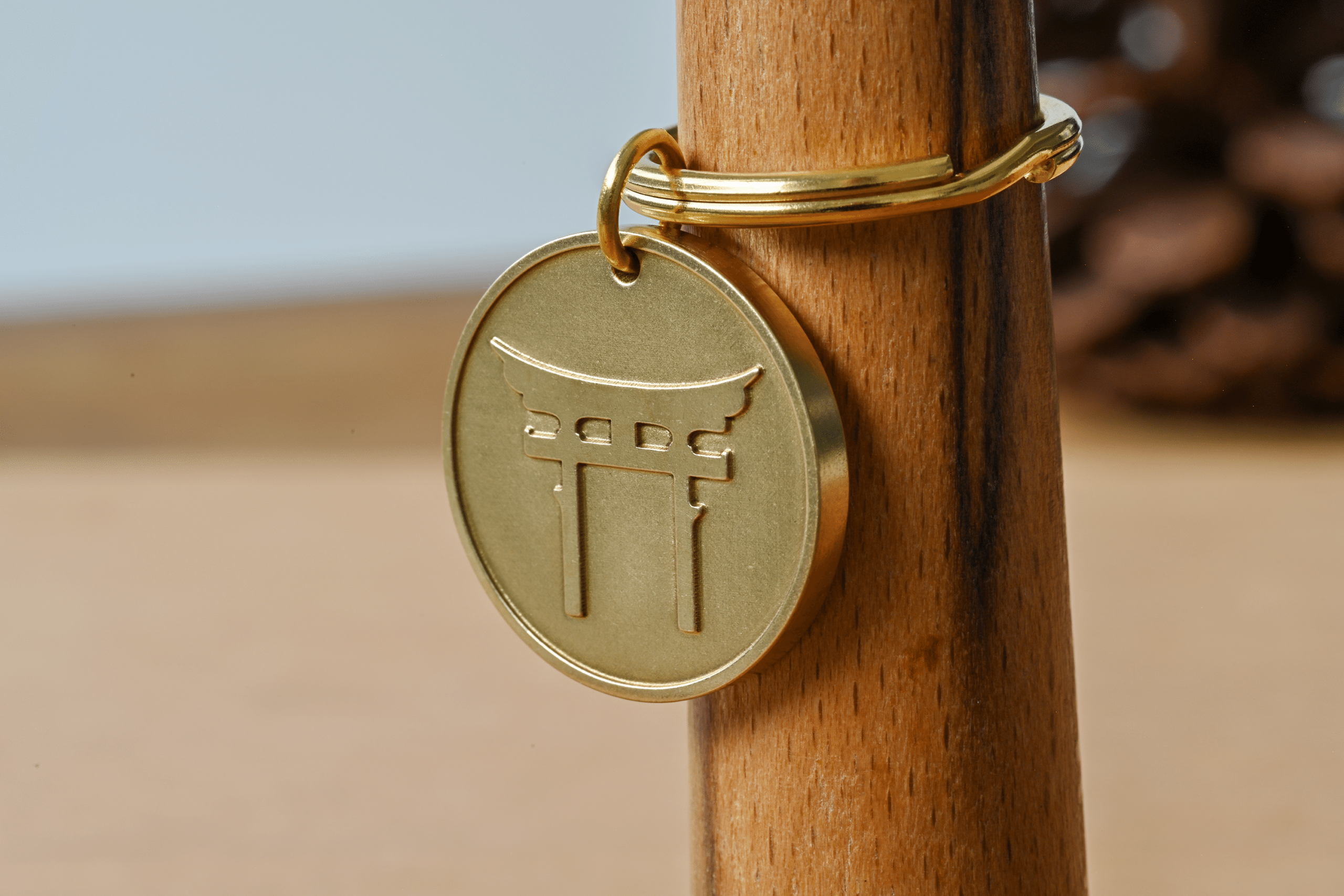 Brass keychain tag engraved with a Japanese torii gate design