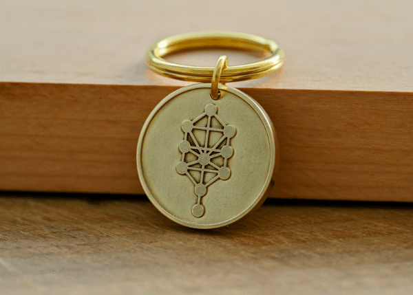 Gold brass keychain featuring a circular pendant engraved with the Kabbalah Tree of Life symbol