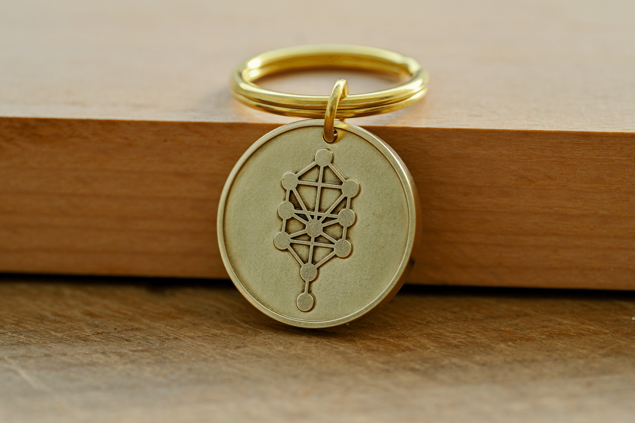 Gold brass keychain featuring a circular pendant engraved with the Kabbalah Tree of Life symbol