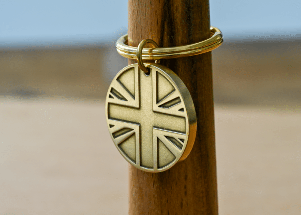 Round brass keychain tag featuring an embossed Union Jack design