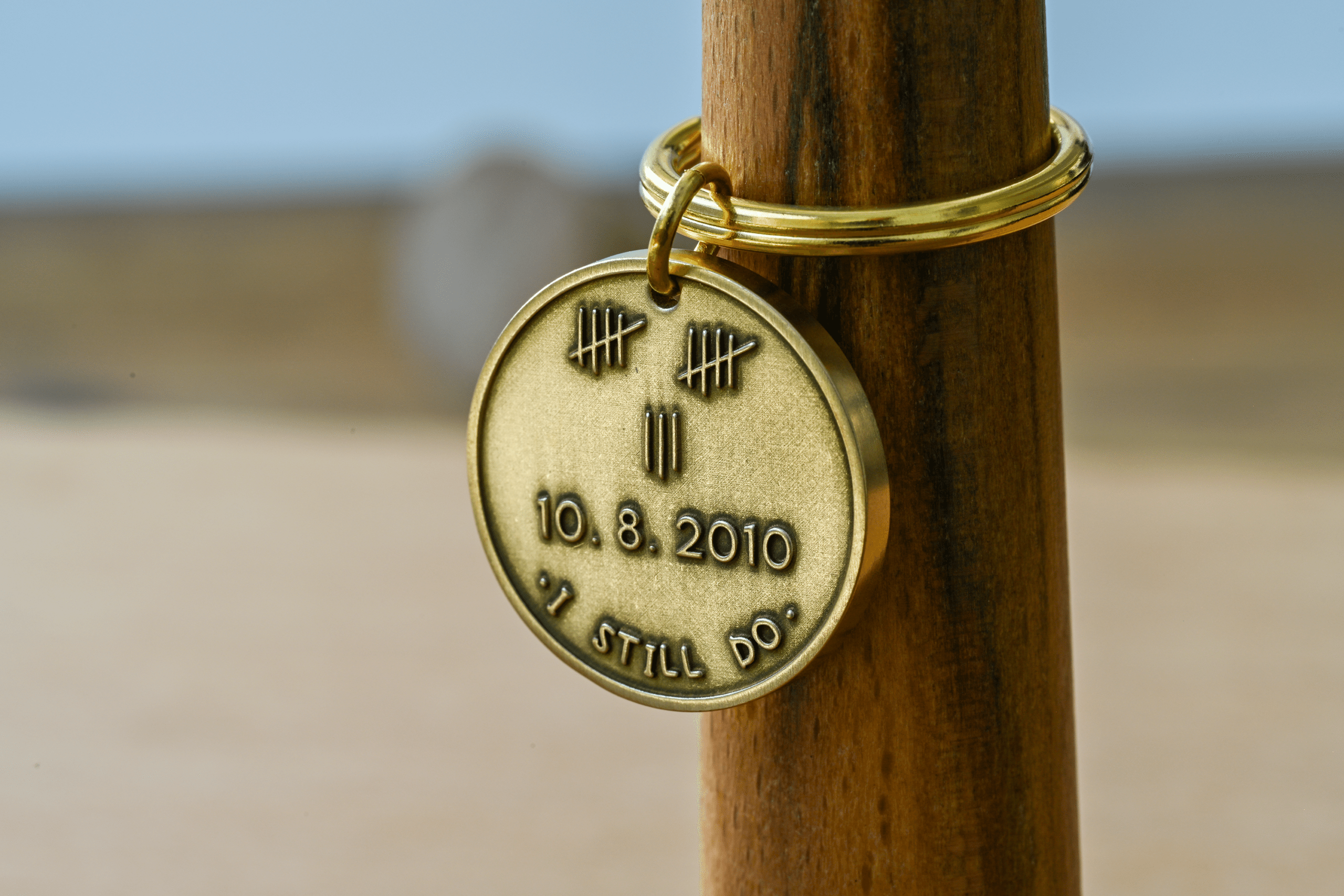 Brass key ring tag engraved with tally marks, the date 10.8.2010, and the phrase I STILL DO