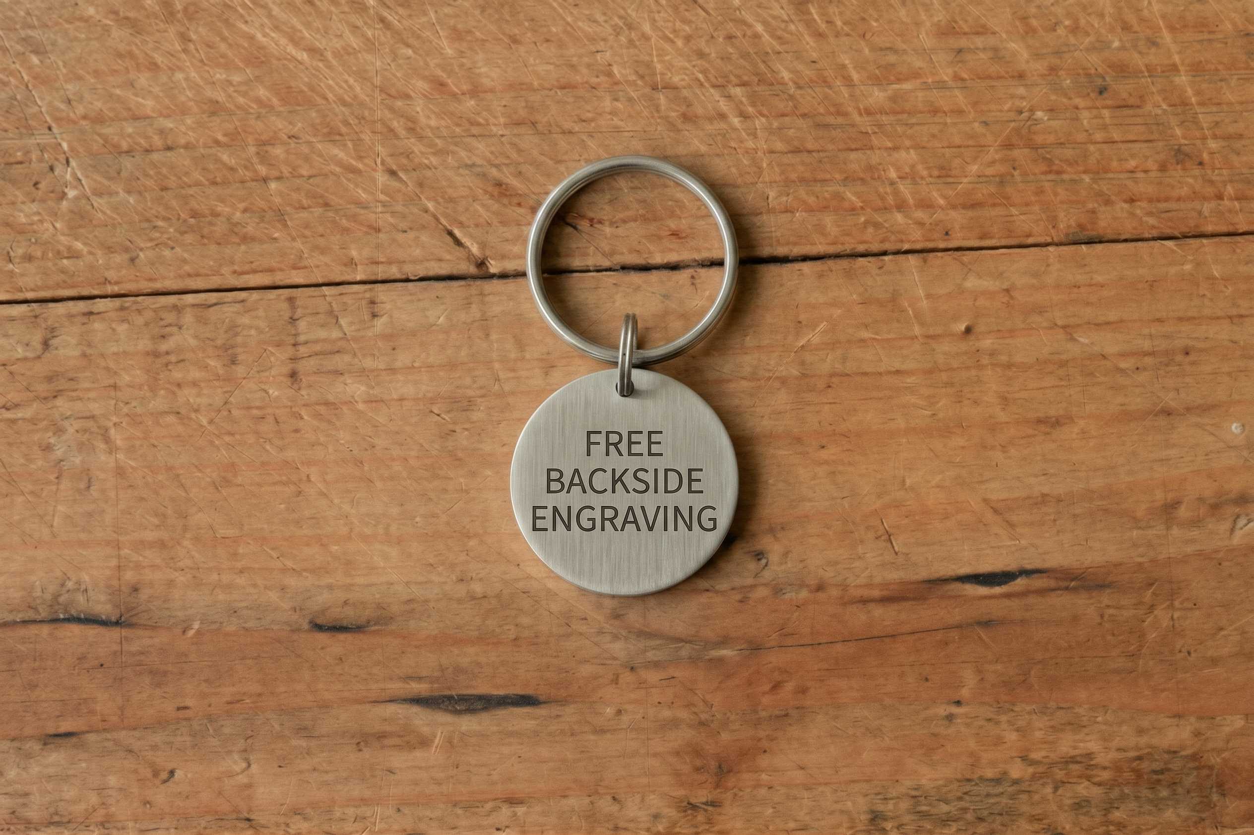 Round metal tag engraved with: FREE BACKSIDE ENGRAVING